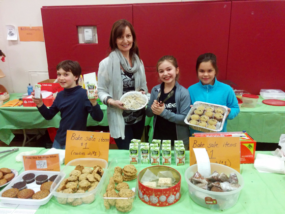 Elmdale parent Giselle Incze volunteers at the bake sale with students Matthew, 8, Callia, 8, and Ava, 9.