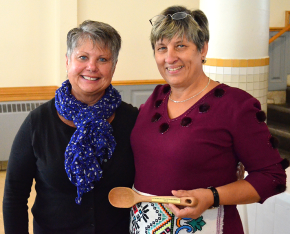 First place winner Raisa Hordichuk (right) accepts her trophy from event organizer Irene Carman. Photos by Jack Lawson.