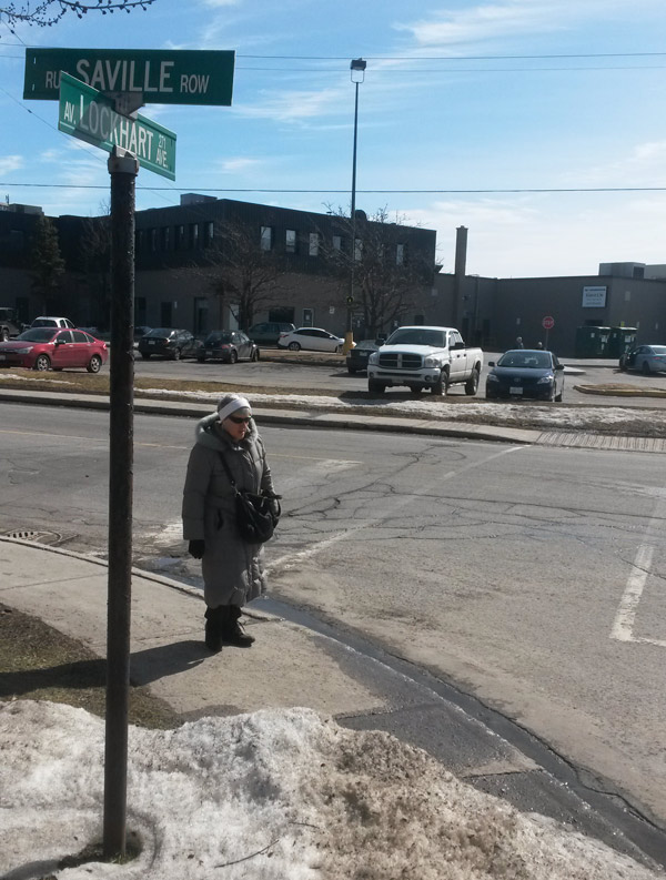 WEB-CMA resident passes by the desire line, seen in the distance. Mall patrons create a desire line into the parking lot, rather than walk approximately 200 meters to the entrance near the YMCA.  Councillor Mark Taylor says Carlingwood Mall isn’t ruling out the possibility of creating an official entrance in the future.