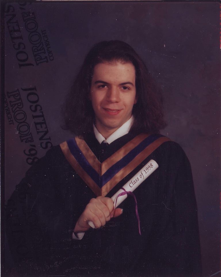 Dave with very long hair in his high school graduation photo. 