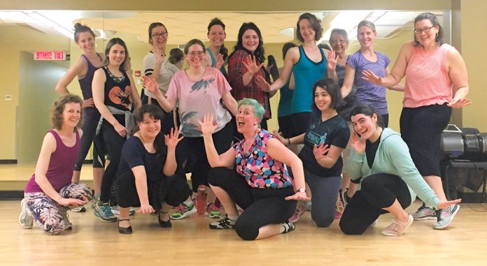 Participants in the Hintonburg Community Centre's Broadway Workout. pose for a photo.