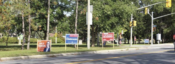 Election signs abound at the intersection of Island Park Drive and Byron||Neighbours gather on Winston Ave for a sit-down supper.|Old photo of Westboro Motors garage and addition.|Ed Weick is one of three Kitchissippi area members of the Sunset Singers.|Anna Jahn||Aleta Moher stands at the bottom of the open stairwell