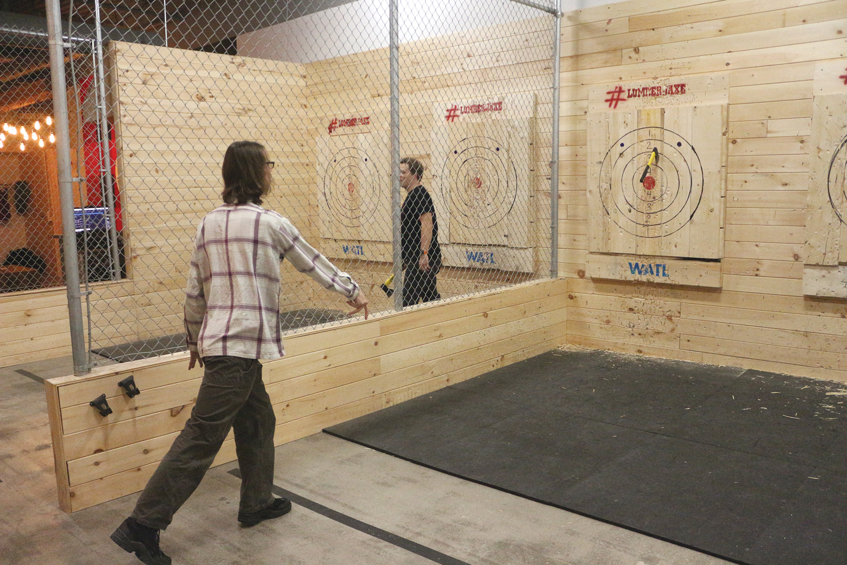 Chad Oldfield, a resident of Westboro, throws an axe towards a target during a company event at Lumberjaxe as part of a company event.