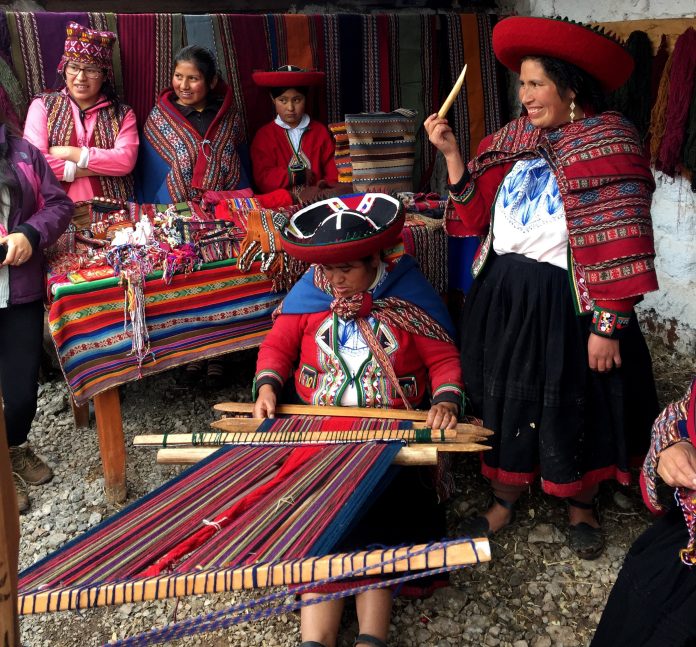 Peruvian women demonstrate weaving techniques.|Meghan Maack