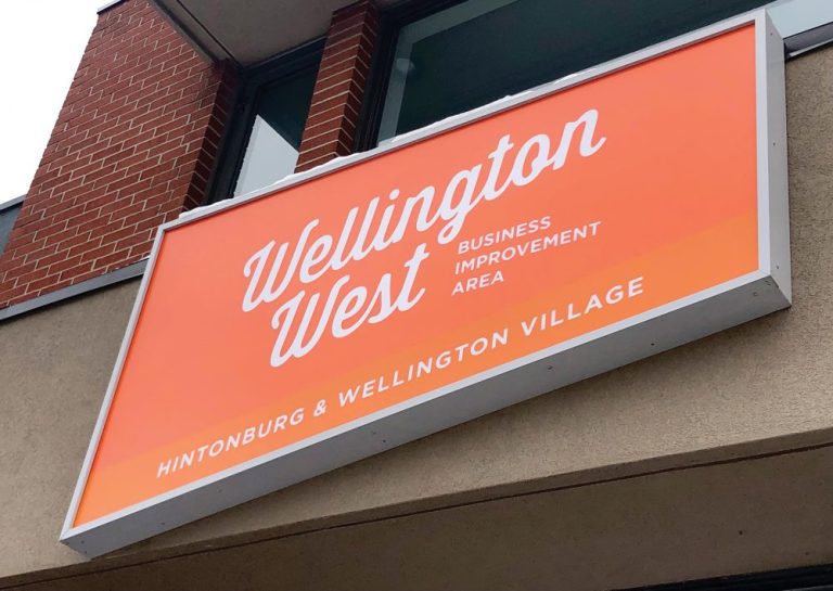 The bright orange sign at the Wellington West BIA building