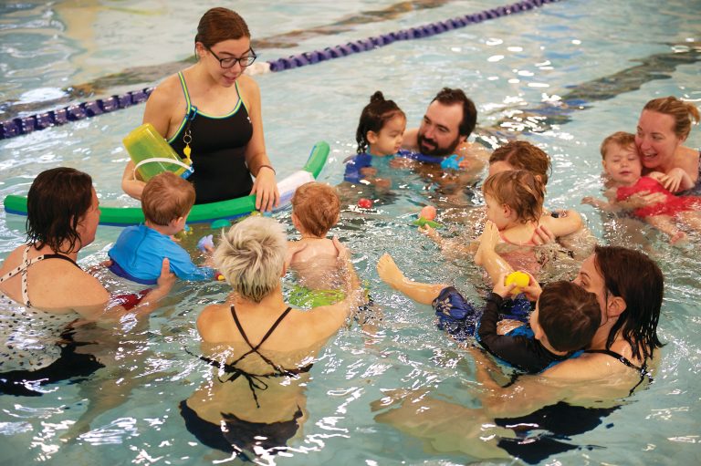 Kids and adults during swimming classes at Dovercourt pool.