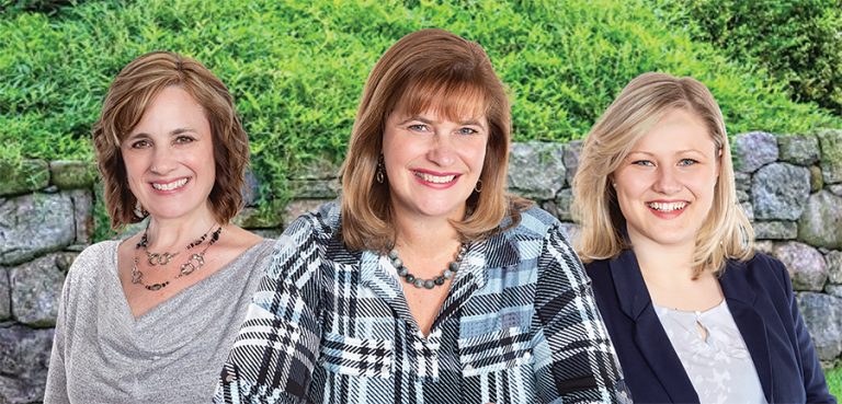 Professional headshots of three Susan Chell agents are seen against a green