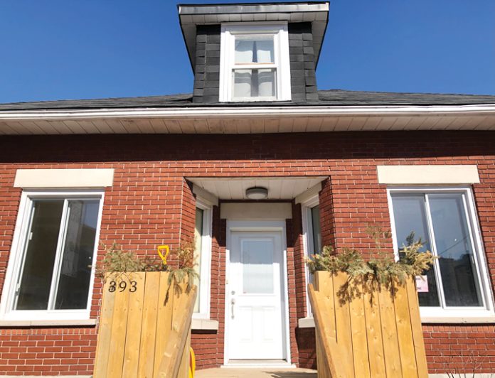 The outside door of The SconeWitch bakery in Westboro on a sunny day