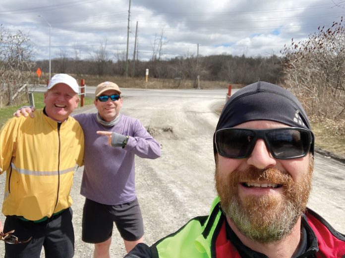 Three men in a selfie photo on a run outside in Ottawa.