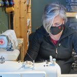 A photo of Cindy Jones sewing a mask in Westboro.