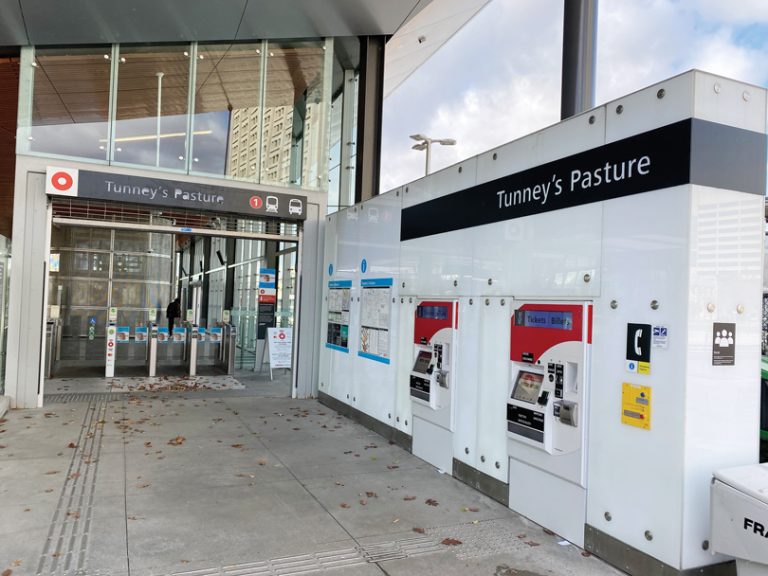 An empty entrance to the Tunney's Pasture LRT train station on a sunny day in November.