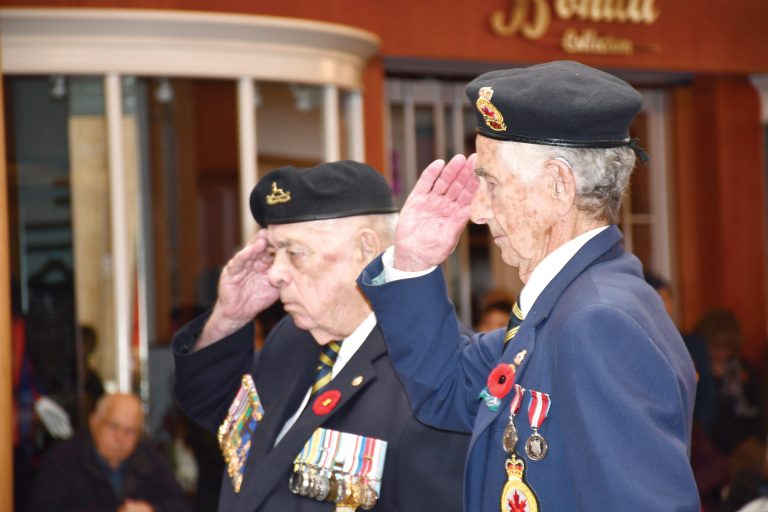 Two veterans saluting at the Carlingwood Mall Remembrance Day ceremony in Ottawa on Nov. 11