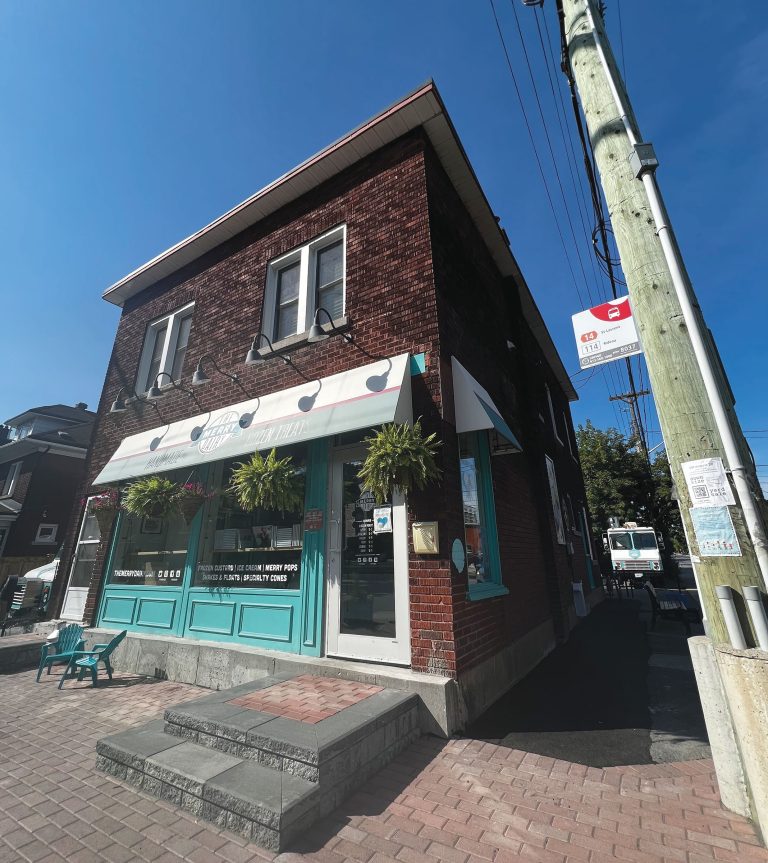 The exterior of the Merry Dairy brick building on a sunny day.||