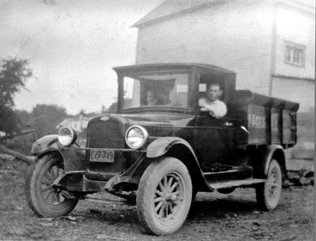 A black and white photo of Jacob and Mary Agnes sitting in a delivery truck in 1927.