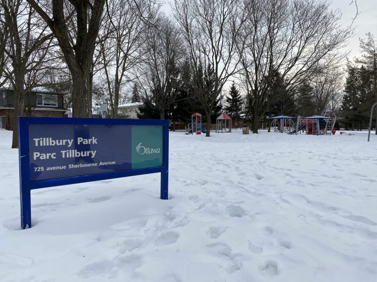 A blue and green City of Ottawa sign reads "Tillbury Park" on a snow covered field in Kitchissippi.|Parkdale Park Community Stage is seen on a snowy day.