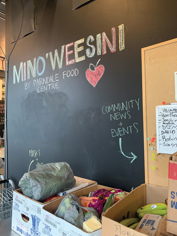 A blackboard for Mino'Weesini shows community news and events. 