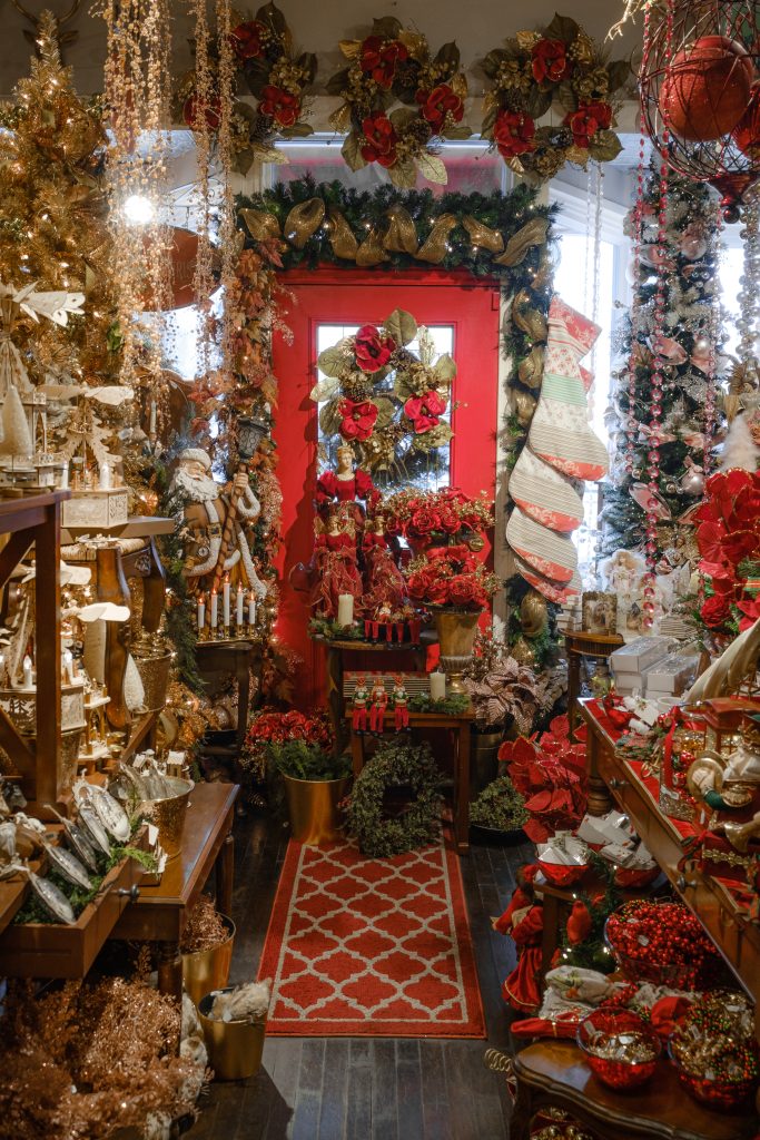 A door decorated with red wreaths at Tinseltown