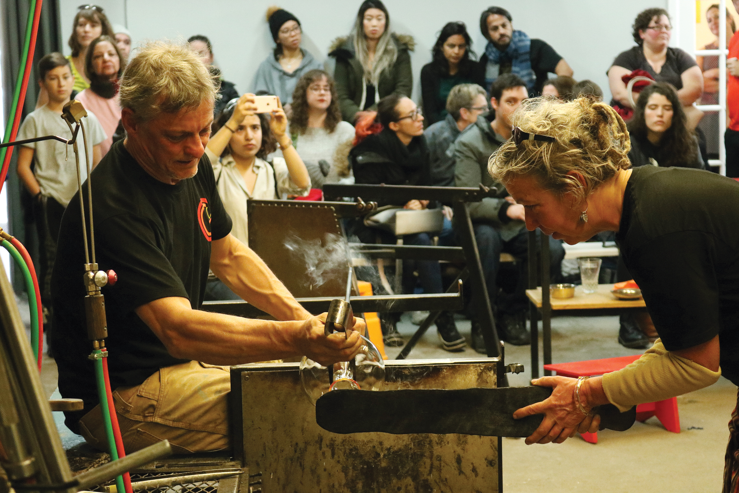 Expert glassblower put on a demonstration of their work for a crowd during the Ottawa Glassblowing Cooperative’s grand opening in November.