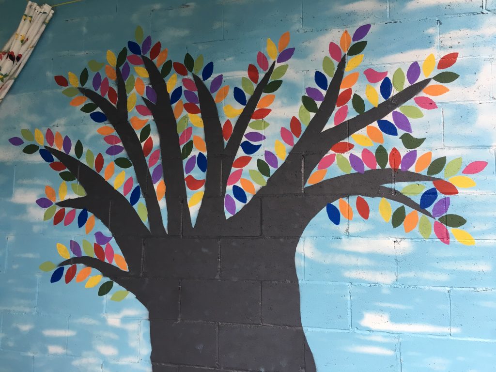 A photo of the colourful tree mural painted by the Thomson family in Hintonburg during the pandemic. 