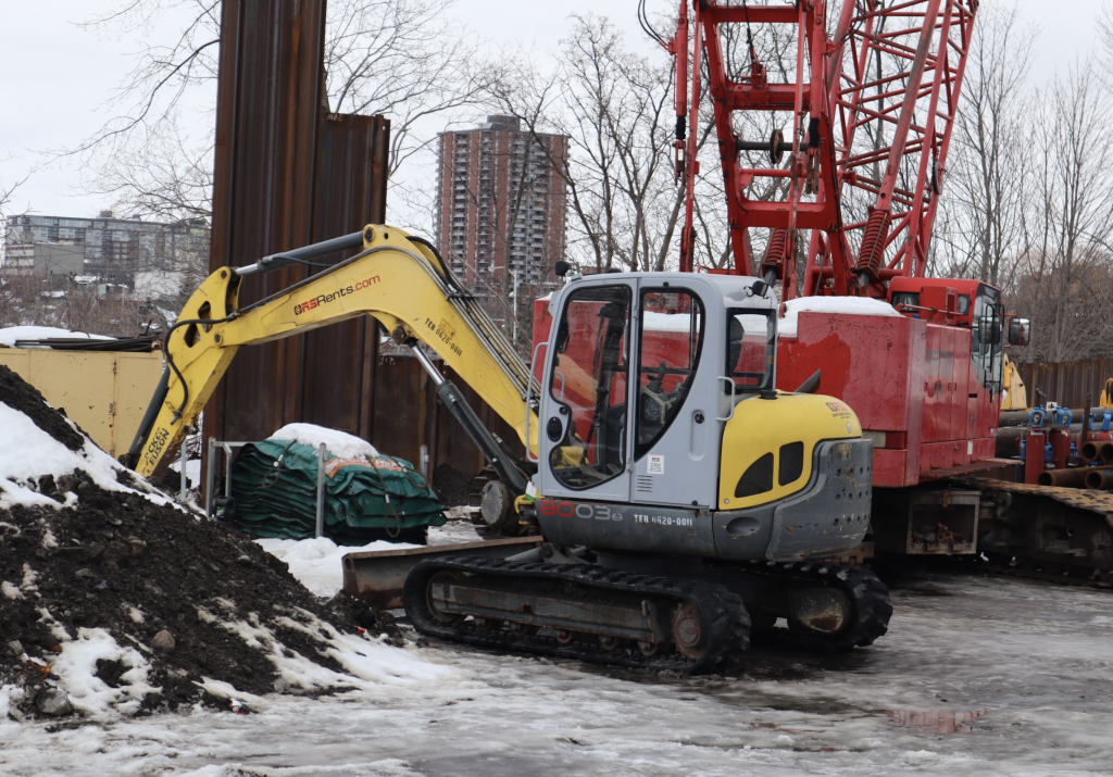 Construction machinery sits idle at a construction site on Breezehill.