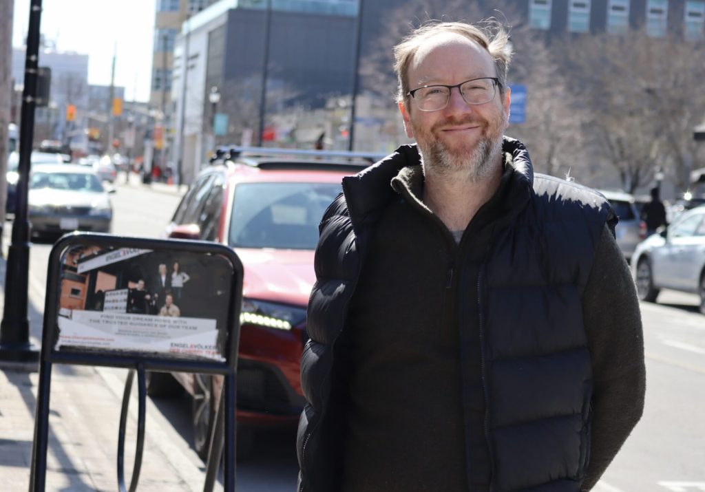 Matt poses for a photo on Wellington Street West. 