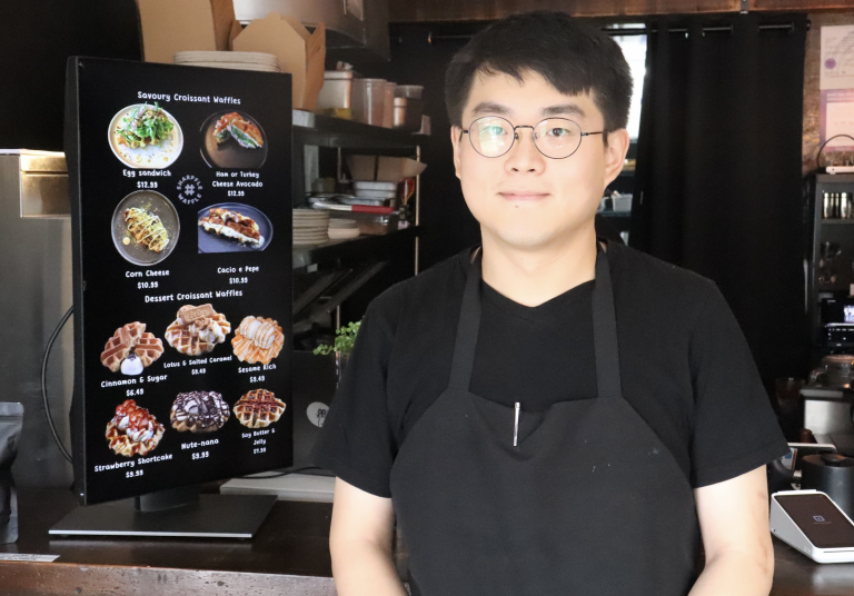 James poses for a photo inside Sharpfle Waffle.