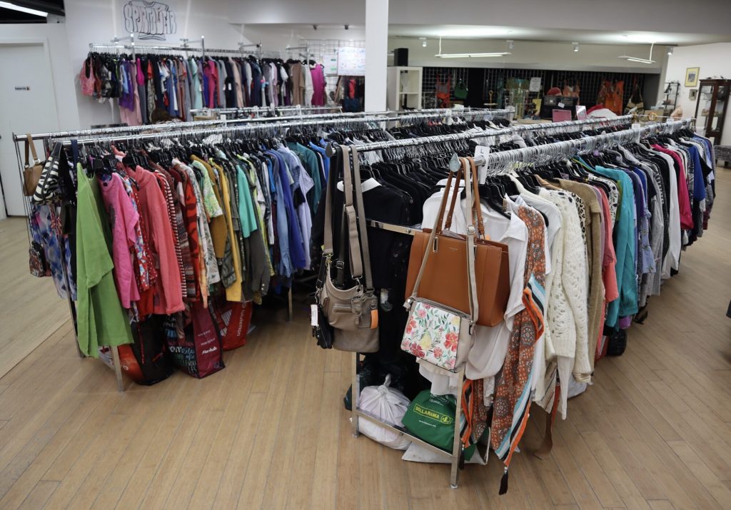 Rows of clothes inside a store. 