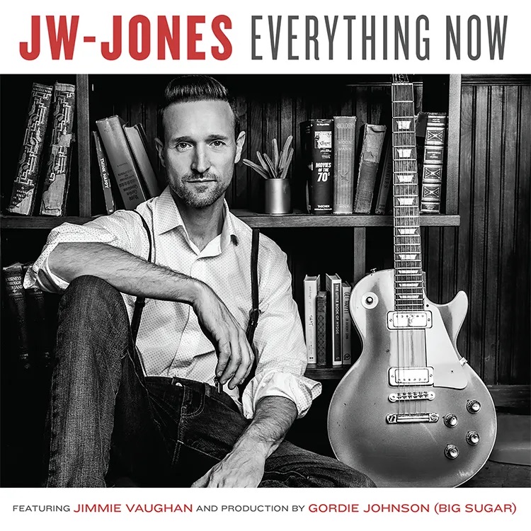 A black and white album cover with a photo of JW Jones sitting on the ground. 