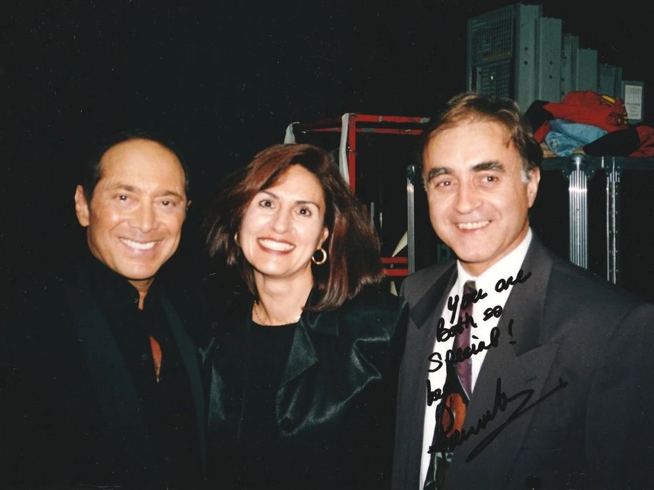 Paul Anka poses for a photo with Tony and Gina Lafaro. It is signed in the corner. 