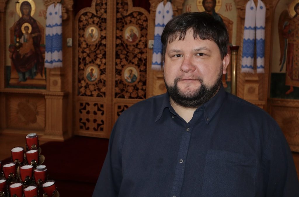 Father Kinash poses for a photo in his church.