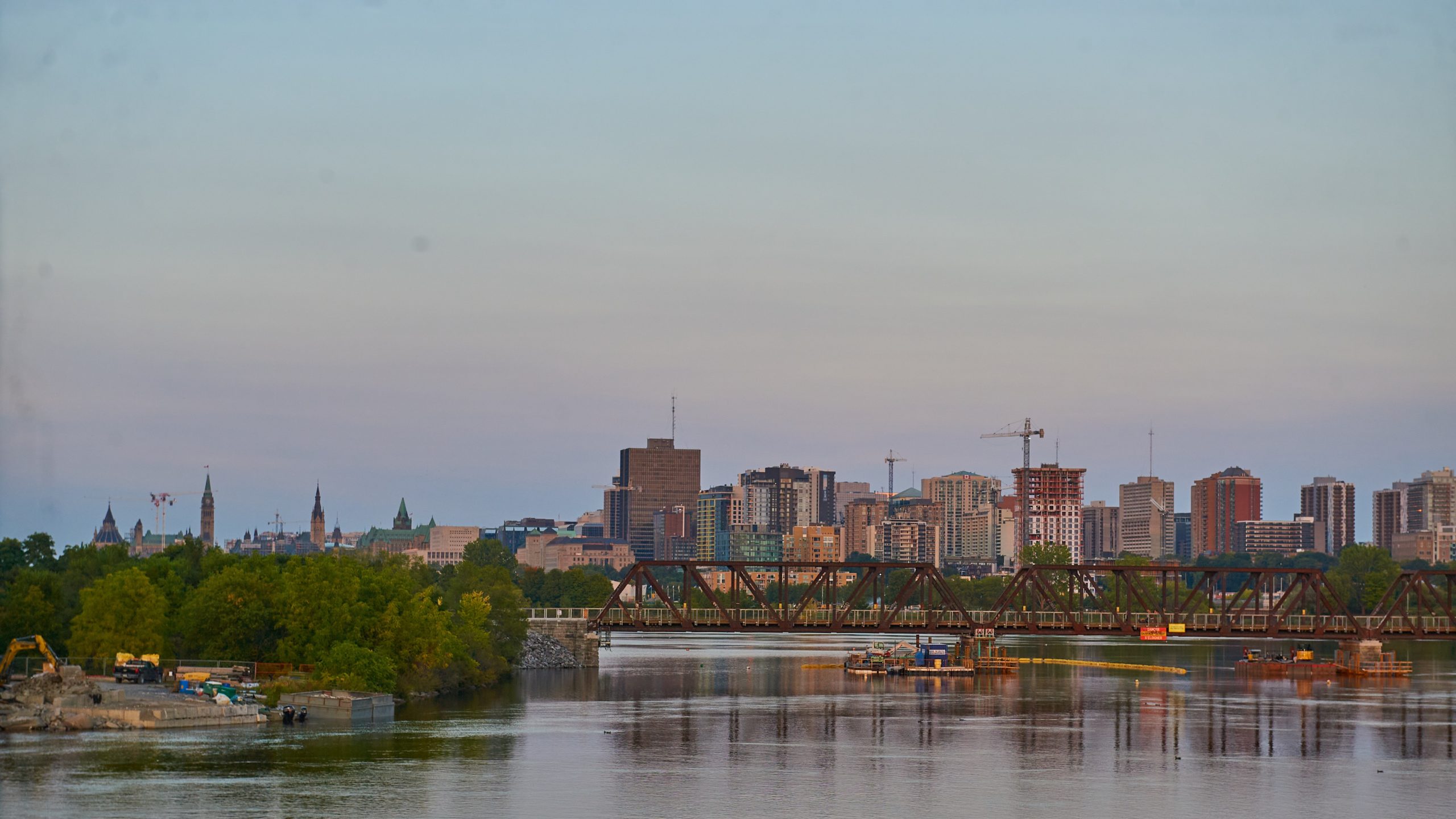 The bridge is seen with the Ottawa skyline in the distance. 