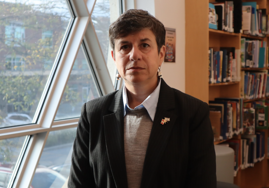 Andrea Freedman poses for a photograph in a library. 