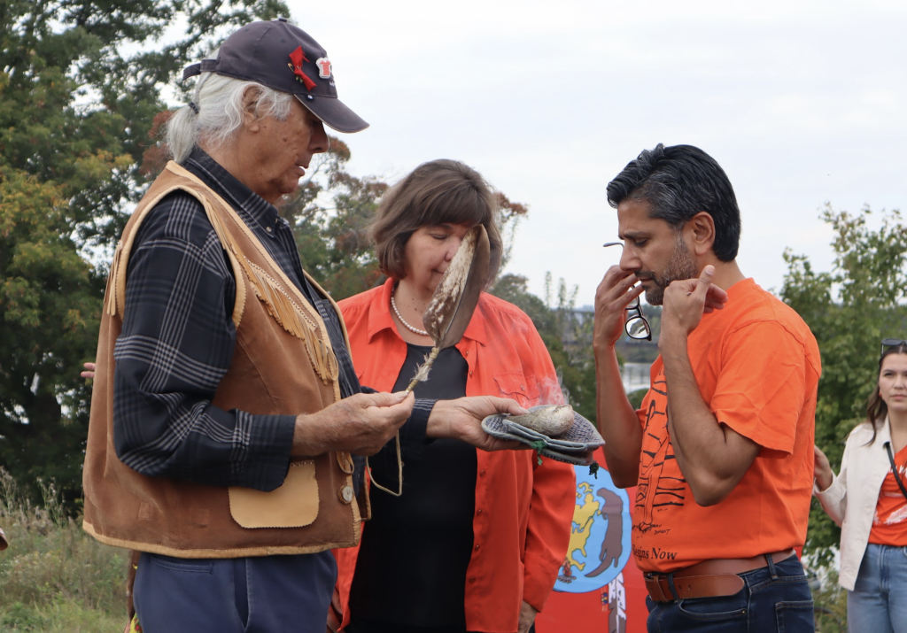 Yasir Naqvi is smudged by an Indigenous elder. 