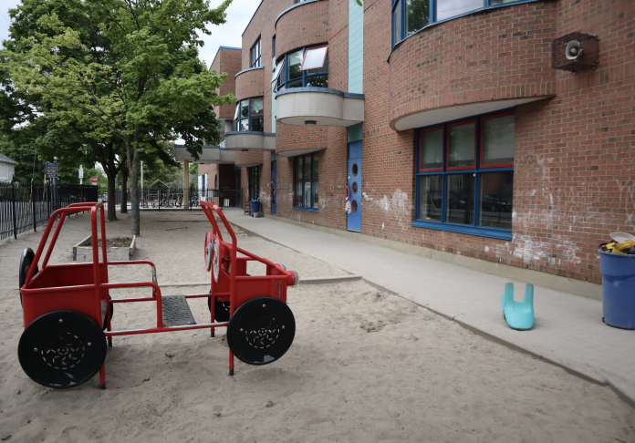 The playground at Churchill Alternative School. There is a big sand pit and a fire’s truck structure which kids can play on.