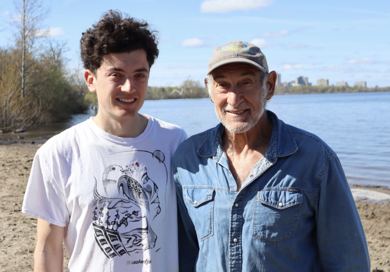 Max and Isaac pose for a photograph at Westboro Beach on a sunny day.