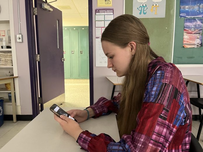 A Nepean High School student checks social media on her phone. Provided photo.