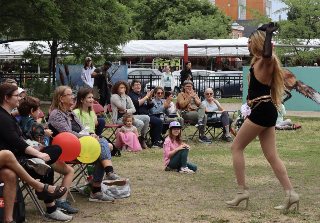 Children watch a Drag Queen dance. 