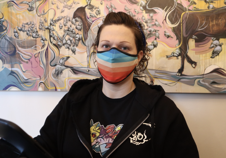 A photo of Lindsay Machinski wearing a pride coloured mask