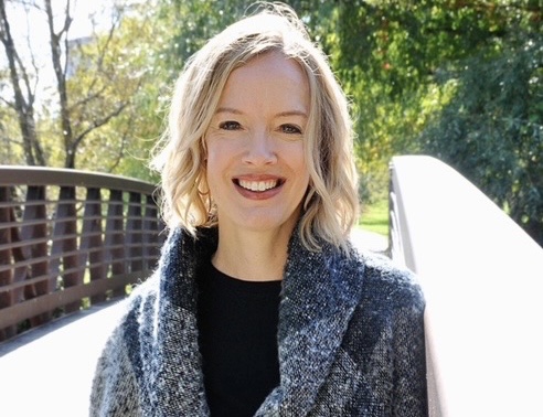 Sonia poses for a photo on a bridge. 