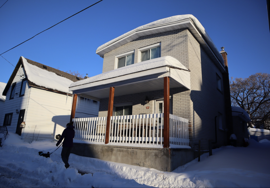 The outside of a house at 22 Ladouceur Street. It has a strong porch. It was taken as the sun was setting.