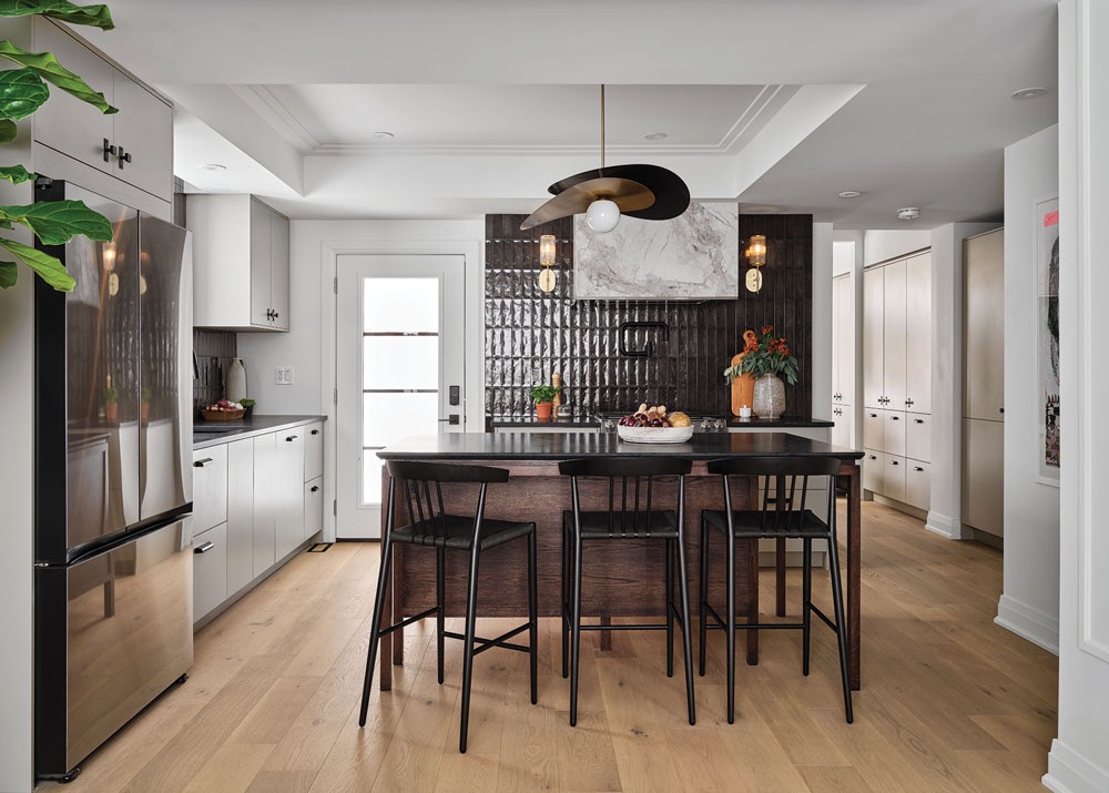 The inside of a kitchen with a bar in the middle. 