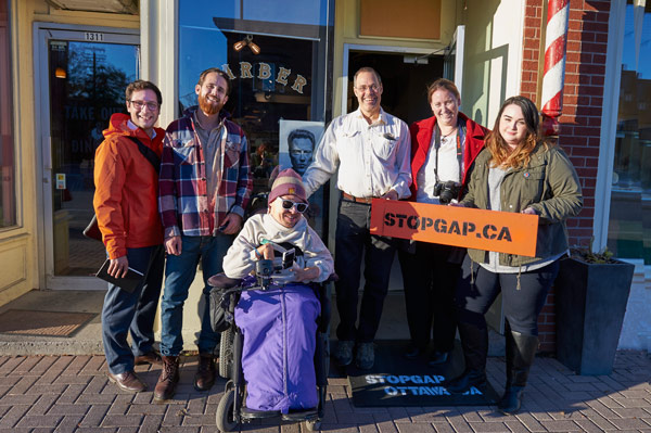 Zach Dayler (Wellington West BIA), Phil Ireland (House of Barons), Chris Binkowski (Accessibility for Humanity), Claude Haridge, Jessica Lahrkamp, and Olivia Keays (Stop Gap Ottawa) deliver an accessibility ramp to House of Barons. Photo by Ellen Bond