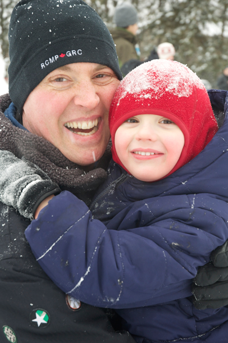 Despite the cold, CJ Angel and his four-year old son, Jack, had a great time at the winter carnival at Woodroffe Park. Photo by Andrea Tomkins