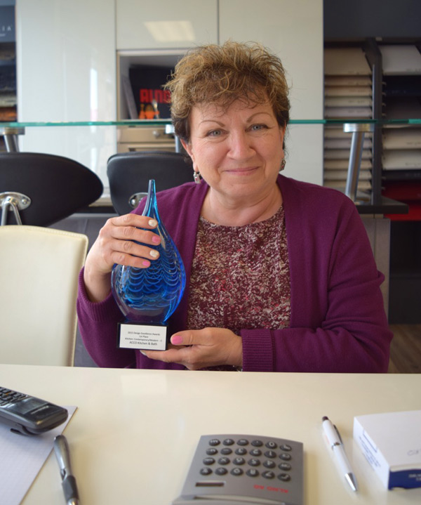 Fanya Zilberbrant, owner of ACCO Kitchen and Bath, with her recent national award. Photo by Alyson Queen