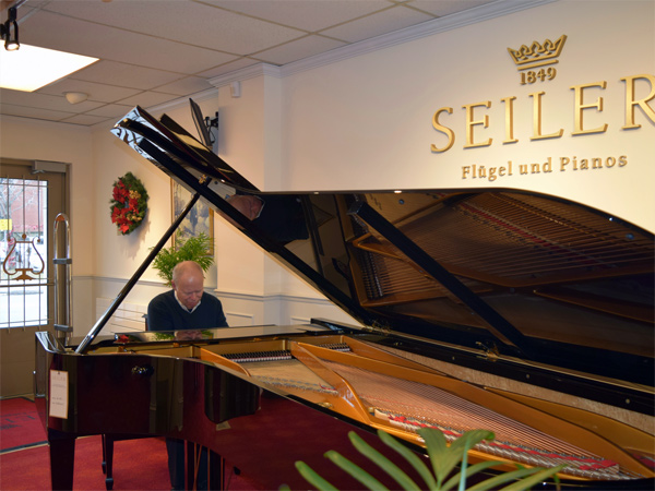 Ken Lauzon of Lauzon Music plays Canada’s only 9-foot Seiler concert grand piano. Photo by Alyson Queen