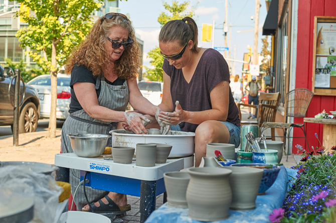 Danika Smith (right) volunteered to try pottery at the Hintonburg Pottery Shop with instructor Ginger McCoy who loves sharing her knowledge and experience with others.