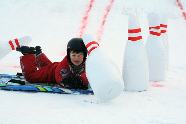 Maddock Currie, 4, happily crashes into the inflatable pins at Dovercourt’s annual winter carnival. Photo by Anita Grace.