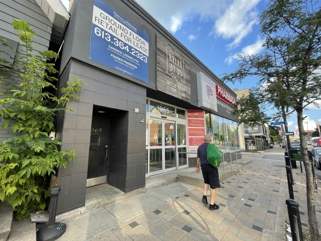 The exterior of a building in Wellington West. A man is walking by.