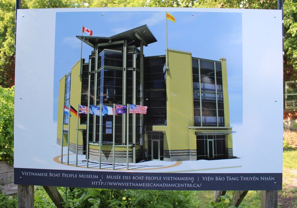 A photo of a sign showing what the new centre could look like.