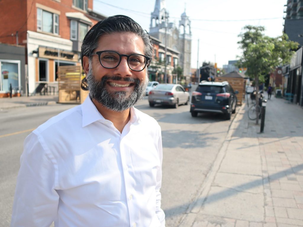 Yasir poses for a photo on Wellington Street West.